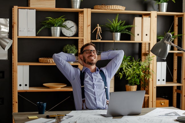 relaxed-happy-businessman-at-work-desk-cafe-table-2021-09-01-15-58-10-utc
